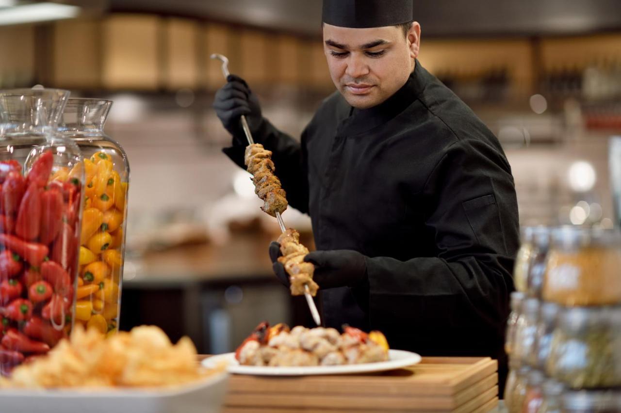 Officers Club & Hotel Abu Dabi Dış mekan fotoğraf A chef preparing food